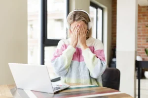 Overwhelmed woman working from home on a laptop